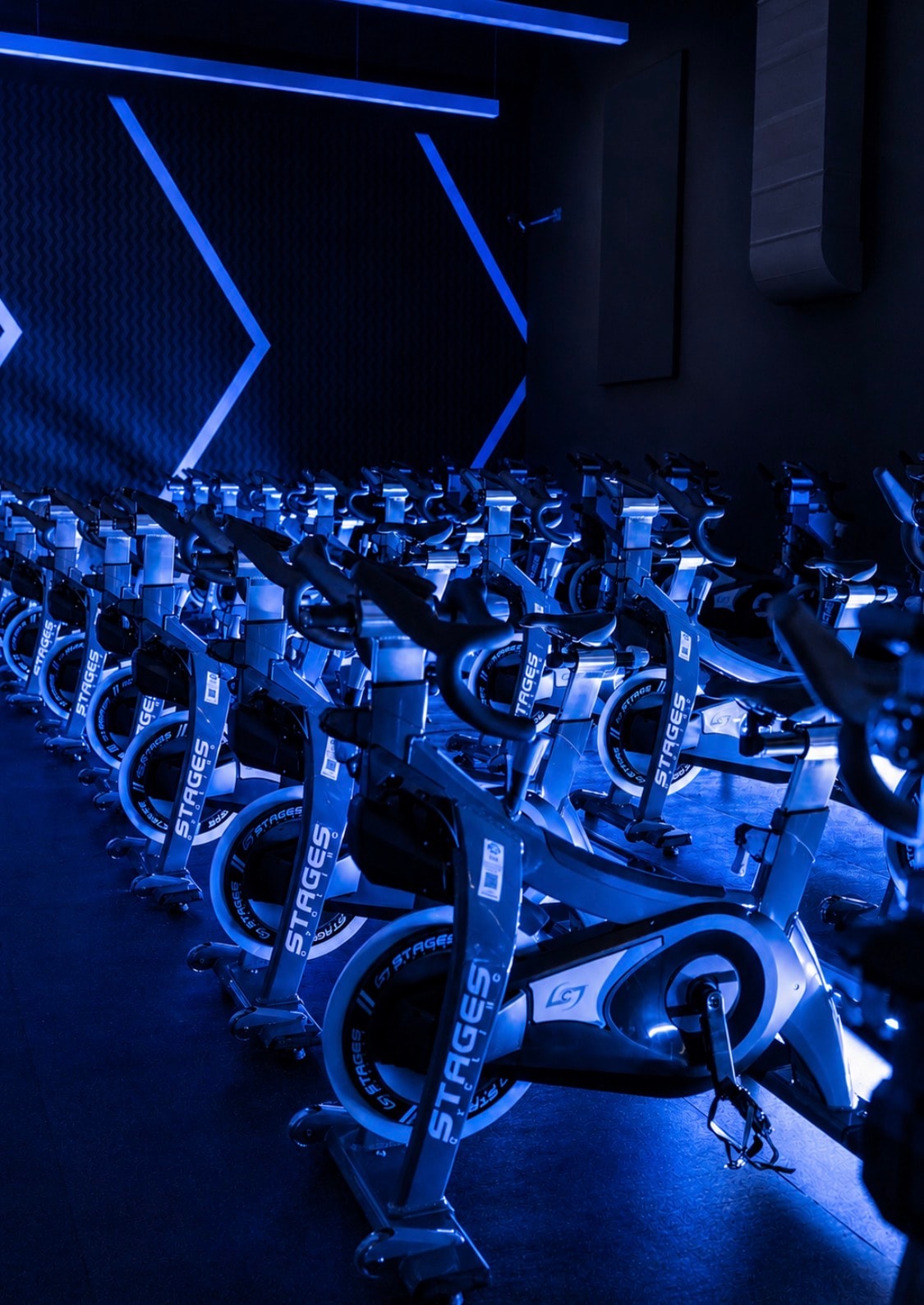 PowerCycle Northville Stages bike studio lit in blue neon